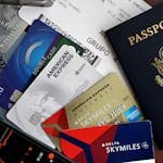 A collection of travel essentials including a passport, credit cards, and a boarding pass. Ideal for travel and finance concepts.