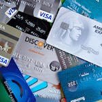 Close-up image of various credit cards including Visa, Mastercard, and American Express.