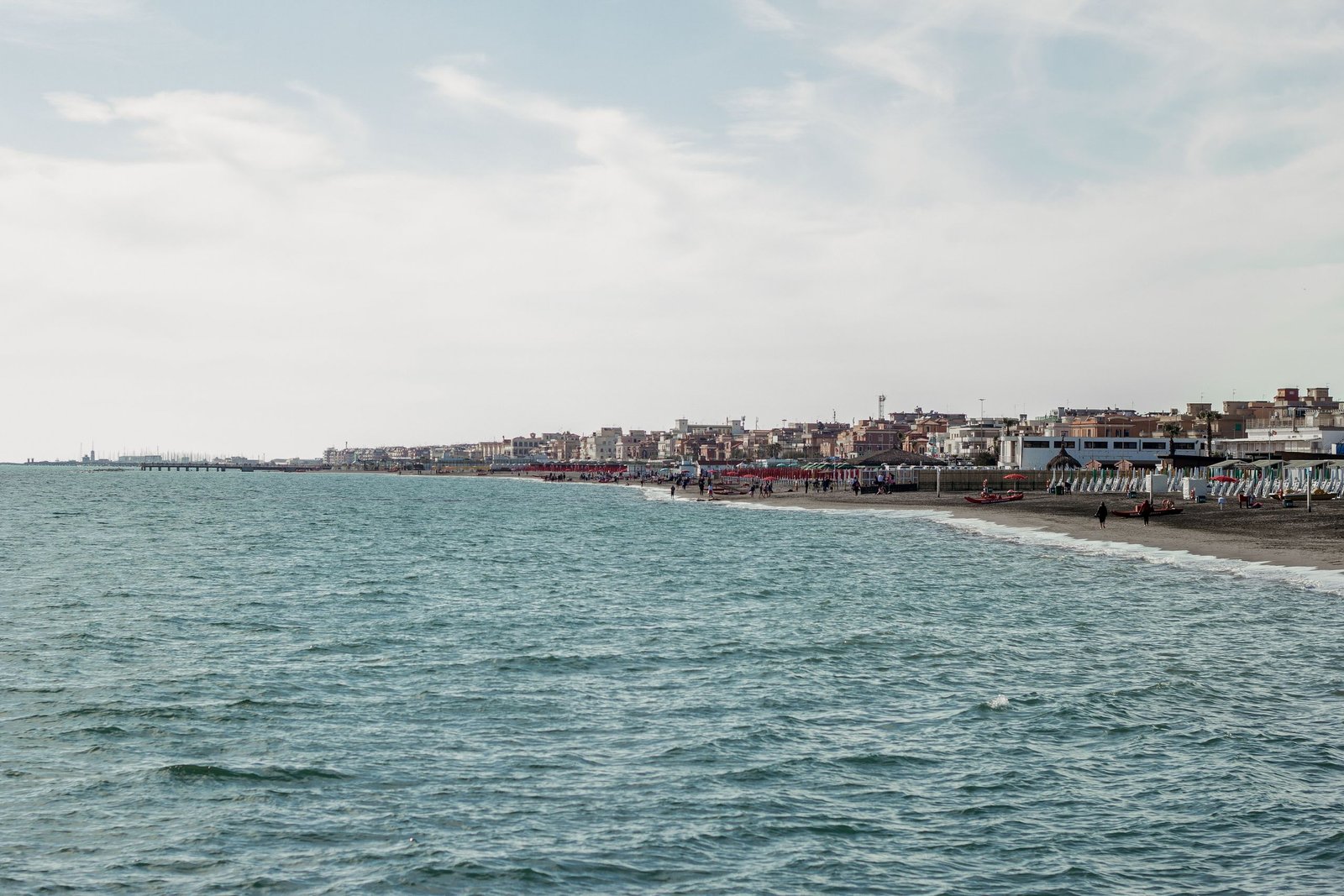 Explore the serene coastline of Rome, Italy with tranquil seawater and beachside scenery.