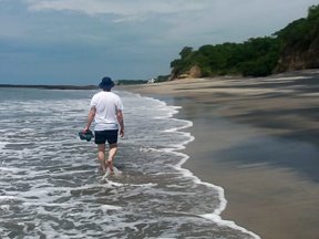 Steve Strong walking along a beach in Panama