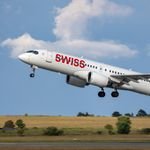 Swiss International Airlines jet taking off from a runway under clear skies, showcasing aviation power.