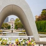 View of Hiroshima Memorial and Atomic Bomb Dome through arch in Peace Park.